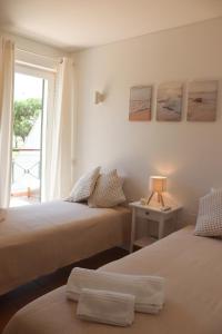 two beds in a room with a window at Luxury Apartment in Vila Sol Resort in Quarteira +33 photos