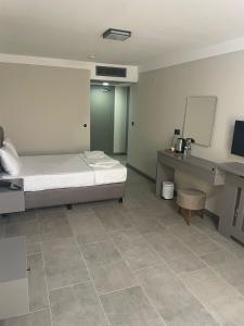 a hospital room with a bed and a desk at Grand Cennet Beach Hotel in Akcay