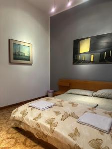 a bedroom with a bed with two towels on it at Bnb fantasia in Bologna