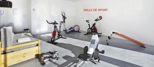 a room with several exercise bikes and a bed at Vue panoramique - Confortable - Piscine - Randonnées - Skis in Font Romeu Odeillo Via