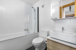 a white bathroom with a toilet and a sink at Silverfox - 6 pers - belle vue in Plan Fey +36 photos