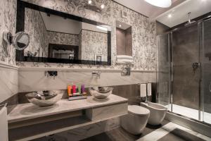 a bathroom with two sinks and a shower at The Inn at the Roman Forum Luxury Collection - The Inn At The Roman Forum in Rome +61 photos