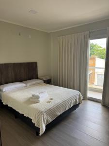 a bedroom with a bed and a large window at Alquileres temporales in Junín