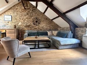 a living room with a couch and a table at Maison de charme cancalaise in Cancale +17 photos