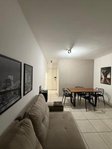 a living room with a couch and a table at Gran Apartamento com Piscina - 3 Quartos in Cuiabá