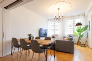 a dining room with a table and chairs at Spacious City View Apartment - Prime Location Biel in Biel