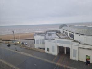 a building by the beach with the ocean in the background at Southcliffe hotel in Bridlington