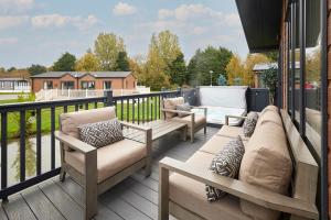 a patio with couches and chairs on a deck at Sandy Lane 20 in York