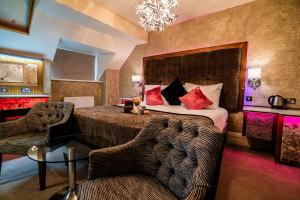 a hotel room with a bed and a chair at The Cranleigh Boutique in Bowness-on-Windermere