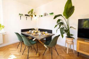 a dining room with a table and chairs and a tv at Modernes Apartment in Altstadtnähe Coburg - kostenloser Parkplatz in Coburg