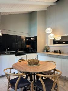 a kitchen with a wooden table and chairs in a kitchen at Casa Illia relax in Funes