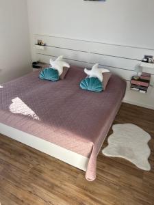 a bedroom with a bed with two pillows at Mira Mare Apartments in Kryvyi Rih +4 photos