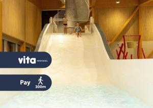 two children on a slide at a water park at Hotel Acropolis " Op het sportiefste park van de kust " in Middelkerke