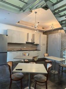 a kitchen with two tables and chairs in it at Sweet Dreams Residence in Brugine
