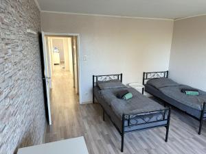 two beds in a room with a brick wall at Monteurunterkunft in Raunheim in Raunheim +6 photos