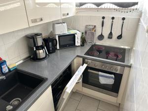 a small kitchen with a stove and a microwave at Monteurunterkunft in Raunheim in Raunheim