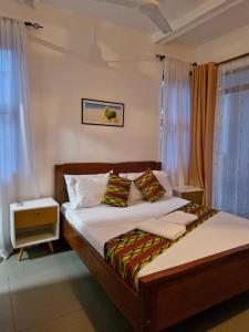 a bedroom with two beds and a night stand at Haradali Suites 2 Bedroom Beach Apartment - Sultan Palace Beach Resort in Kilifi +30 photos