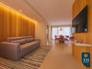 a living room with a couch and a table at Praia do Forte 2 bedrooms Complete and Comfortable in Mata de Sao Joao
