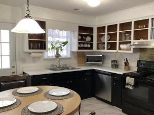 a kitchen with a table with two plates on it at Simply Home in Statesboro