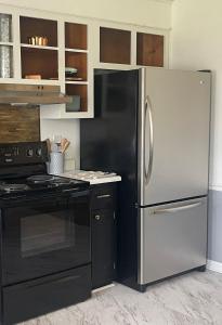 a kitchen with a black and stainless steel refrigerator at Simply Home in Statesboro