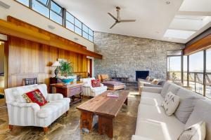 a living room with white furniture and a stone wall at Rackliff Island Hideaway in Spruce Head