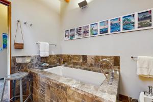 a bathroom with a tub and a sink at Rackliff Island Hideaway in Spruce Head +17 photos