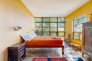 a bedroom with a bed and a large window at Rackliff Island Hideaway in Spruce Head
