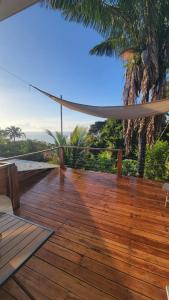 a wooden deck with a hammock on a beach at Casa Boa Casita in La Abuela +7 photos