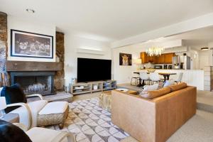 a living room with a couch and a fireplace at Glacier D in Teton Village