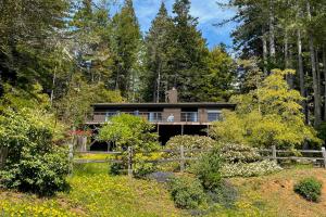 a house in the woods with a fence at Sea Raven in Gualala
