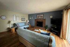 a living room with a couch and a fireplace at High View in Dyer Cove