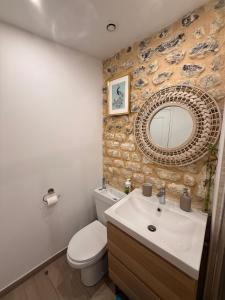 une salle de bain avec un lavabo, des toilettes et un miroir dans l'établissement Maison Marie Charme & confort à Rouen centre, à Rouen 23 autres photos