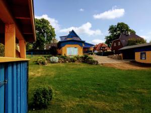 a house with a blue roof in a yard at Am Blauen See in Dabel