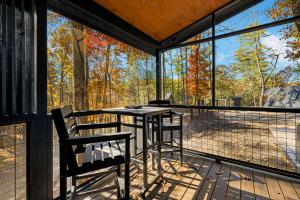 una veranda riparata con tavolo e sedie di A Place & Time a Lickskillet