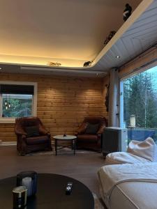 a living room with couches and a tv at Green Garden Oslo - Luxury Resort in Kolbotn