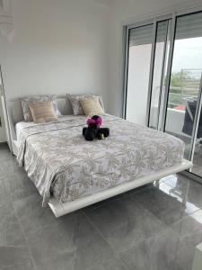 a teddy bear sitting on a bed in a bedroom at Villa Bel'Horizon in Capesterre +23 photos