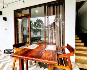 a wooden table and chairs in a room at Eyeful Ella in Ella