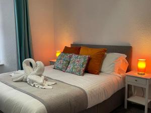 a bedroom with a bed with a stuffed animal on it at Tintagel Arms Bed and Breakfast in Tintagel +2 photos