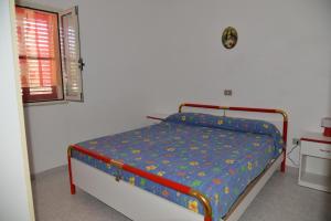 a bedroom with a bed in a room with a window at Canto delle Rane in Vieste