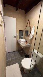 a bathroom with a toilet and a sink and a mirror at Casa 678 in Belém +24 photos
