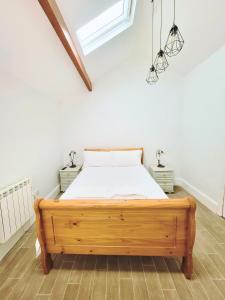 a bedroom with a wooden bed in a room at Kings' House in Douglas