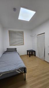 a bedroom with a bed and a skylight at 스테이 노랑 stay norang in Daegu