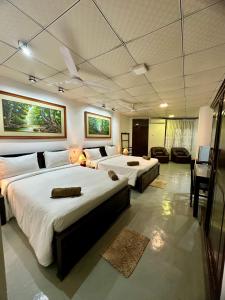 a hotel room with two beds in a room at Paragon Mirissa in Mirissa