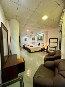 a flooded room with a bed and chairs in it at Paragon Mirissa in Mirissa