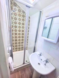 a bathroom with a sink and a shower at Kings' House in Douglas