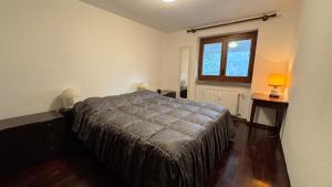 a bedroom with a bed and a window at L'Atelier du Temps - Voicing House in Courmayeur