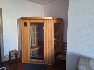 a wooden cabinet with a bird cage in a room at Petite maison proche cathédrale centre 3 pers in Toul