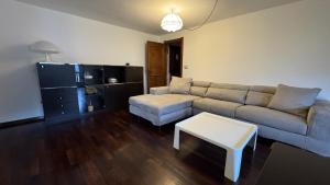 a living room with a couch and a table at L'Atelier du Temps - Voicing House in Courmayeur +5 photos