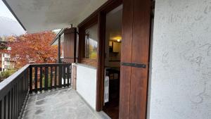a balcony with a wooden door on a building at L'Atelier du Temps - Voicing House in Courmayeur