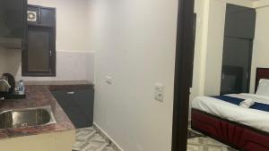 een badkamer met een wastafel en een bed in een kamer bij Hotel Glass Castle Near Yashobhoomi in New Delhi +31 foto's